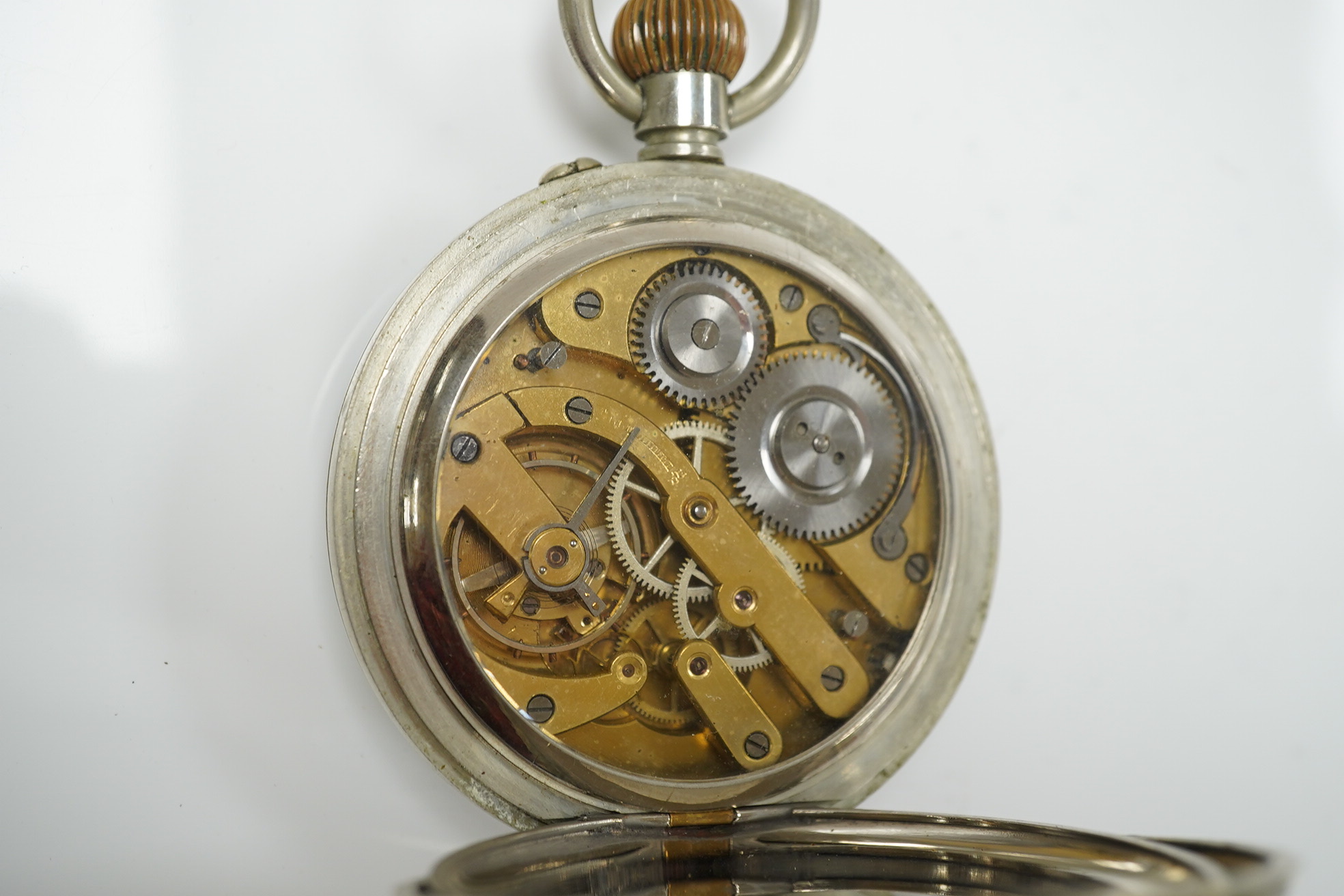 An Edwardian repousse silver mounted travelling watch case, maker W.?, Chester, 1902, 11.1cm, containing a nickel cased pocket watch. Condition - poor to fair